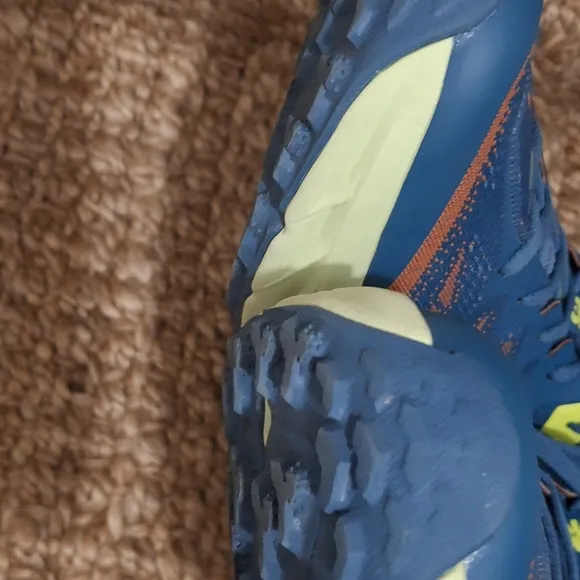 The HOKA Speedgoat 5 is a highly cushioned, technical trail running shoe designe